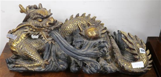 An Oriental giltwood figure of a dragon